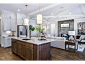 Gourmet kitchen with stainless steel appliances, stylish pendant lighting, and an island with seating at 223 Harvester Rd, Angier, NC 27501