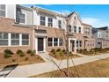 Attractive townhome showcasing brick and siding exterior, complemented by a well-maintained lawn at 260 Chesapeake Commons St # 156, Garner, NC 27529