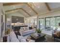 Bright living area connected to the kitchen and a screened-in porch, perfect for indoor-outdoor living at 306 Golden Leaf Farms Rd, Angier, NC 27501