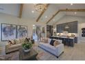 Spacious living room with stylish sofas, a decorative rug, and views into the modern kitchen area at 306 Golden Leaf Farms Rd, Angier, NC 27501