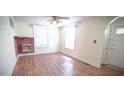 Inviting living room with hardwood floors, a brick fireplace, and lots of natural light from the windows at 3117 Cheek Rd, Durham, NC 27704