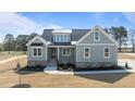 Beautiful craftsman home featuring stone accents, neutral siding, black metal roof accents, and manicured landscaping at 35 Wheatfield Ln, Youngsville, NC 27596