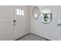 Bright entryway with modern mirrors, sleek door, and stylish rug at 523 Old Battle Bridge Rd, Wendell, NC 27591