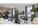 Bright living room with contemporary decor, stylish furniture, and large windows at 523 Old Battle Bridge Rd, Wendell, NC 27591