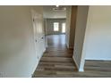 Inviting hallway with wood-look flooring leading to a bright and airy living space at 55 E Victory View. Ter, Smithfield, NC 27577