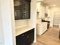 New kitchen has white cabinets, stainless steel appliances, a pantry, and quartz countertops at 62 Blue Iris Pkwy # 125, Clayton, NC 27520