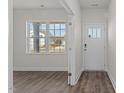 Inviting entryway featuring a white door with glass panels and durable wood-look flooring at 832 Canis Minor Rd, Wendell, NC 27591