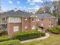 Brick condo building showcasing well-maintained landscaping and architecture at 100 Edenburgh Rd # 202, Raleigh, NC 27608