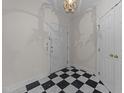 Home foyer featuring checkered flooring, a chandelier, and a white front door at 100 Edenburgh Rd # 202, Raleigh, NC 27608