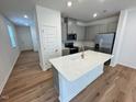 Modern kitchen with stainless steel appliances and a center island at 10523 Brookside Reserve Rd, Raleigh, NC 27614