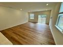 Spacious living room with hardwood floors and ample natural light at 10523 Brookside Reserve Rd, Raleigh, NC 27614