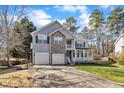 Charming two-story home with stone accents, a two-car garage, and a basketball hoop at 1079 Vauxhall Dr, Apex, NC 27502