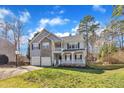 Charming two-story home with stone accents, a two-car garage, and a grassy front yard at 1079 Vauxhall Dr, Apex, NC 27502