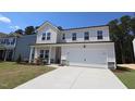 Charming two-story home featuring a covered porch and a two-car garage, landscaped yard and a bright exterior at 1229 Dimaggio Dr # 8, Raleigh, NC 27616