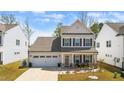 Beautiful two-story home with a two-car garage, covered porch and manicured landscaping at 1311 Arena Ln, Fuquay Varina, NC 27526