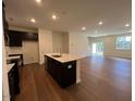 Stylish kitchen features an island, dark cabinets, and an open floor plan at 144 Parker Ln, Mebane, NC 27302