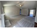 Open-concept living room featuring high ceilings, plush carpeting, fireplace, and ample natural light at 145 Magnolia Run Way, Benson, NC 27504