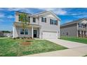 Charming two-story home featuring a two-car garage, landscaped yard, and a welcoming entrance at 156 Paper Birch Way, Fuquay Varina, NC 27526