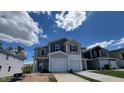 Charming townhome with blue and gray exterior, showcasing a well-maintained yard on a sunny day at 160 Parker Ln, Mebane, NC 27302