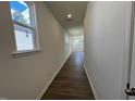 Bright hallway featuring hardwood floors and natural light streaming through the windows at 160 Parker Ln, Mebane, NC 27302