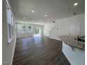 Spacious living room with hardwood floors, large windows, and sliding glass doors at 160 Parker Ln, Mebane, NC 27302