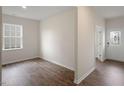 A well-lit, versatile empty room with wood floors and natural light from a window at 168 Paper Birch Way, Fuquay Varina, NC 27526