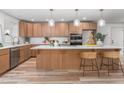 Modern kitchen featuring custom wood cabinets, a spacious island with bar seating, and stainless steel appliances at 206 Ellington Rd, Graham, NC 27253