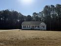 Inviting single-story home with a well-manicured lawn and charming facade at 209 Magnolia Run Way, Benson, NC 27504