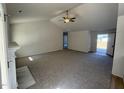 Bright living room featuring vaulted ceilings, plush carpeting, and a fireplace at 209 Magnolia Run Way, Benson, NC 27504