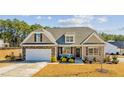 Charming home with stone accents, covered front porch, dormer windows, and an attached garage at 25 Bourne Dr, Franklinton, NC 27525