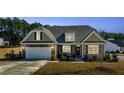 Charming home exterior features stone accents, a covered porch, and well-manicured landscaping at 25 Bourne Dr, Franklinton, NC 27525