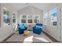 Bright sun room with vaulted ceiling and windows on three sides showcasing outdoor view at 25 Bourne Dr, Franklinton, NC 27525