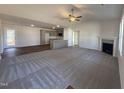 Open floor plan view of the living room, connecting to the kitchen and dining area at 275 Magnolia Run Way, Benson, NC 27504