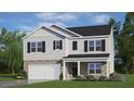 Charming two-story home with a brick and vinyl exterior, a welcoming front porch, and attached garage at 276 Hanging Elm Ln, Fuquay Varina, NC 27526