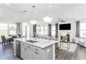 Open-concept kitchen with island seamlessly connects to the living area and breakfast nook at 304 Arcadius Dr, Clayton, NC 27520