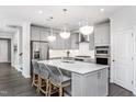 A modern kitchen featuring an island with bar seating, stainless steel appliances, and ample storage at 304 Arcadius Dr, Clayton, NC 27520