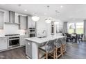Bright kitchen boasts a central island with pendant lighting, stainless appliances, and eat-in dining space at 304 Arcadius Dr, Clayton, NC 27520