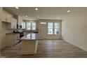 Open-concept kitchen features white cabinets, granite countertops, and modern appliances at 314 Church St # 37, Wendell, NC 27591