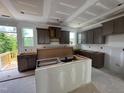 Spacious new construction kitchen with cabinetry and an island awaiting appliances and finishing at 315 Chesapeake Commons St # 102, Garner, NC 27529