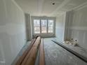 A new construction living room featuring multiple windows for natural light at 315 Chesapeake Commons St # 102, Garner, NC 27529