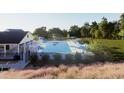 Community pool features lounge seating, umbrellas, splash fountain, and a covered seating area at 315 Chesapeake Commons St # 102, Garner, NC 27529