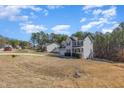 View of home's exterior with two-car garage, black shutters and landscaping at 329 Silver Creek Dr, Clayton, NC 27520