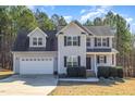 Charming two-story home with a two-car garage, black shutters, and manicured landscaping at 329 Silver Creek Dr, Clayton, NC 27520