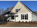 Charming two-story home with black shutters, white siding, and a covered porch for a welcoming curb appeal at 333 S Main St, Four Oaks, NC 27524