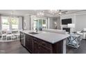 Open concept kitchen with quartz countertops, stainless appliances, and dark wood flooring at 344 Arcadius Dr, Clayton, NC 27520