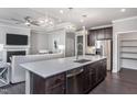 Spacious open-concept kitchen featuring dark cabinets, stainless appliances and a large island at 344 Arcadius Dr, Clayton, NC 27520