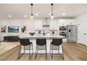 Stunning kitchen with granite island, stainless appliances, and modern lighting fixtures at 344 Church St, Morrisville, NC 27560