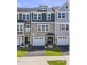 Charming townhomes feature stone accents, complementary siding, and neat front lawns at 509 Sherron Rd # 22, Durham, NC 27703