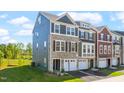 Beautiful exterior view of new townhomes with stone accents, siding, and well-maintained landscaping at 509 Sherron Rd # 22, Durham, NC 27703