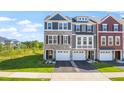 Beautiful townhome showcasing stone accents, a single car garage, and a well manicured lawn at 509 Sherron Rd # 25, Durham, NC 27703